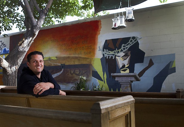 Pastor Chris Chapel poses in the courtyard at Casa de Luz, a small church in the Naked City area Monday, April 15, 2013. The church, which currently services about 1,800 area residents with a food pantry, is beginning on a major renovation project.