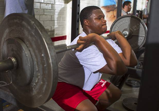 Valley High School football player Noble Hall lifts weights with the team at school weight room Monday, April 15, 2013. Hall recently changed his name from Eric Burrell to Noble Hall (his father's name) to honor his father who was killed before he was born.