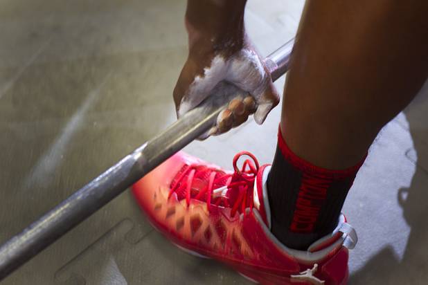 Chalk covers the hand of Valley High School football player Noble Hall as he works out with the team at Valley Monday, April 15, 2013. Hall recently changed his name from Eric Burrell to Noble Hall (his father's name) to honor his father who was killed before he was born.