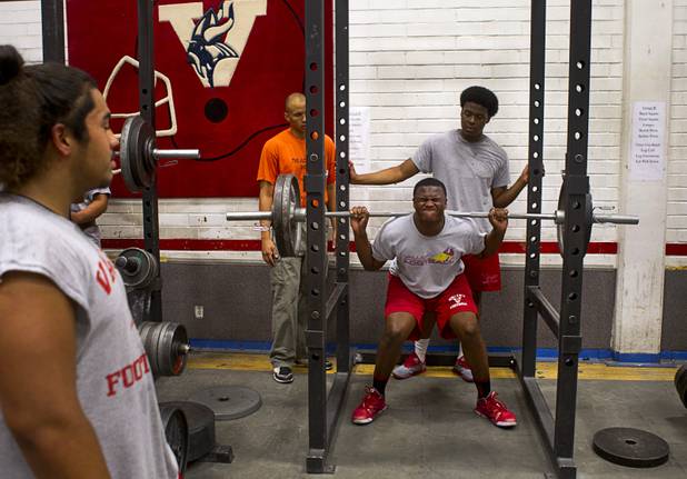 Valley High School football player Noble Hall lifts weights with the team at school weight room Monday, April 15, 2013. Hall recently changed his name from Eric Burrell to Noble Hall (his father's name) to honor his father who was killed before he was born.