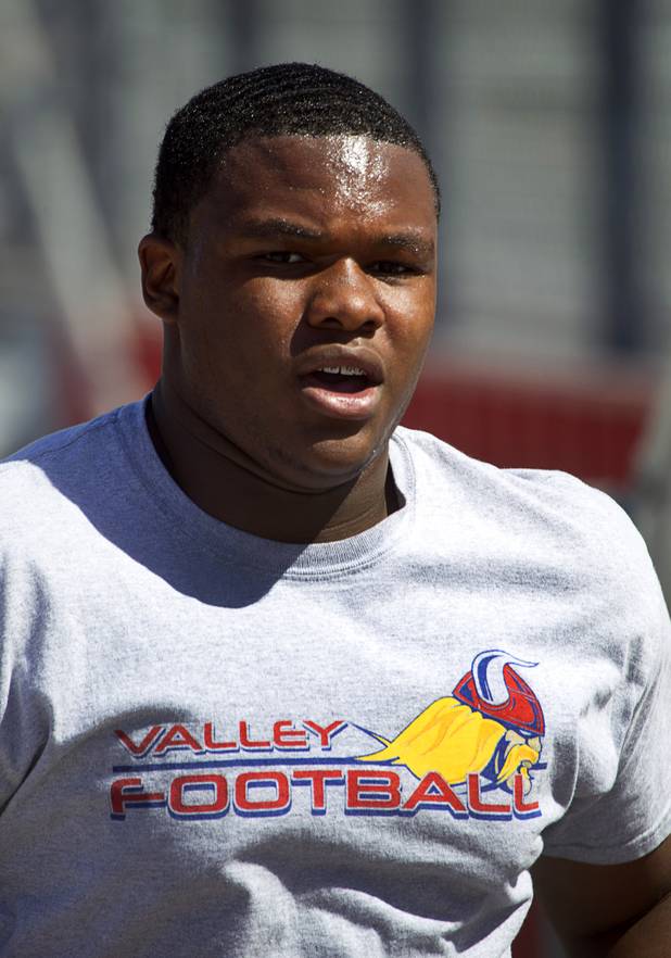 Valley High School football player Noble Hall works out with the team at Valley Monday, April 15, 2013. Hall recently changed his name from Eric Burrell to Noble Hall (his father's name) to honor his father who was killed before he was born.