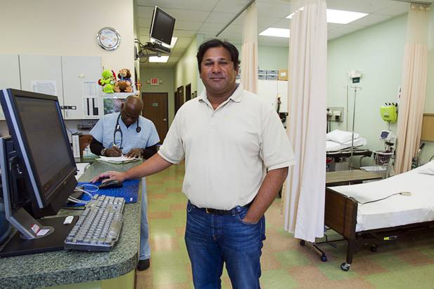 Dr. Govind Koka poses by observation bays at the Advanced Urgent Care clinic, 9975 S. Eastern Ave., Monday, April 15, 2013. Koka co-owns the clinic with Dr. Craig Jorgenson.