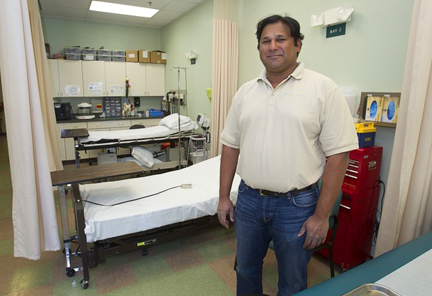 Dr. Govind Koka poses by observation bays at the Advanced Urgent Care clinic, 9975 S. Eastern Ave., Monday, April 15, 2013. Koka co-owns the clinic with Dr. Craig Jorgenson.