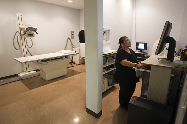 X-ray technician Doris Basa works at the Advanced Urgent Care clinic, 9975 S. Eastern Ave., Monday, April 15, 2013.