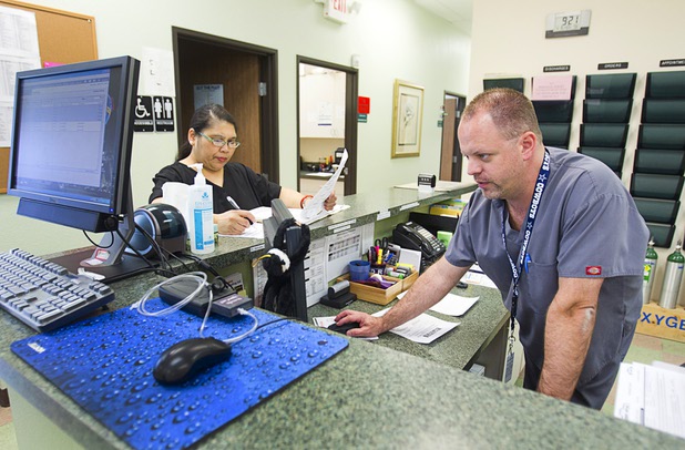 X-ray technician Doris Basa and back office supervisor Bryan Holmes work in the Advanced Urgent Care clinic, 9975 S. Eastern Ave., Monday, April 15, 2013.