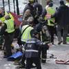 Medical workers aid injured people at the finish line of the 2013 Boston Marathon following an explosion in Boston, Monday, April 15, 2013. 