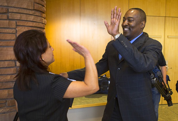 Tyrone Thompson, right, gets a high five from Meli Pulido after he was appointed to replace expelled Nevada Assemblyman Steven Brooks during a county commission meeting at the Clark County Government Center Tuesday, April 16, 2013. Pulido was also a candidate in the selection process. 