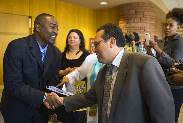 Tyrone Thompson, left, is congratulated after he was appointed to replace expelled Nevada Assemblyman Steven Brooks during a county commission meeting at the Clark County Government Center Tuesday, April 16, 2013.