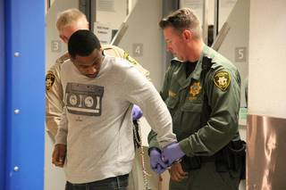 Ammar Harris is brought to the Clark County Detention Center on April 16, 2013, to be booked on charges related to a shooting and fiery crash on the Las Vegas Strip in which three people were killed Feb. 21, 2013.