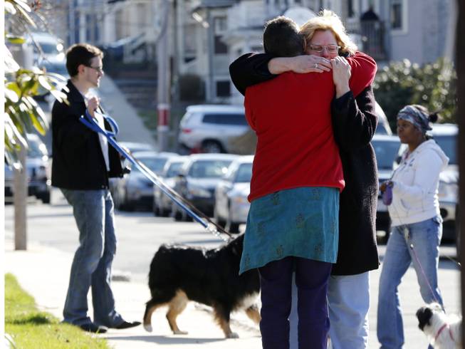 Neighbors hug outside the home of the Richard family in the Dorchester neighborhood of Boston, Tuesday, April 16, 2013.  Martin Richard, 8,  was killed in Mondays bombing at the finish line of the Boston Marathon.