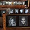 Photos of local celebrities and patrons line the booths in the cafe at the Golden Palm Hotel Tuesday, April 16, 2013.