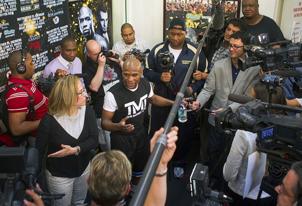 Undefeated welterweight boxer Floyd Mayweather Jr. is surrounded by reporters before a media work out at the Mayweather Boxing Club Wednesday, April 17, 2013. Mayweather will defend his WBC welterweight title against Robert Guerrero at the MGM Grand Garden Arena on May 4.