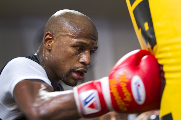 Undefeated welterweight boxer Floyd Mayweather Jr. hits a heavy bag at the Mayweather Boxing Club Wednesday, April 17, 2013. Mayweather will defend his WBC welterweight title against Robert Guerrero at the MGM Grand Garden Arena on May 4.