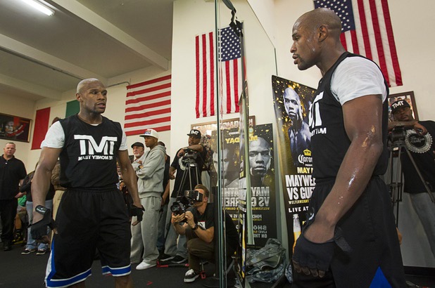 Undefeated welterweight boxer Floyd Mayweather Jr. looks at his reflection in a mirror during a workout at the Mayweather Boxing Club Wednesday, April 17, 2013. Mayweather will defend his WBC welterweight title against Robert Guerrero at the MGM Grand Garden Arena on May 4.