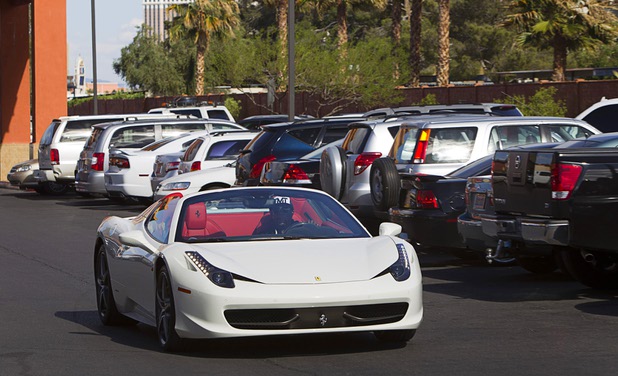 Undefeated welterweight boxer Floyd Mayweather Jr. arrives for a workout in a Ferrari convertible at the Mayweather Boxing Club Wednesday, April 17, 2013. Mayweather will defend his WBC welterweight title against Robert Guerrero at the MGM Grand Garden Arena on May 4. 