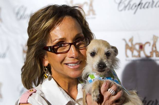 Chrissi Scinta holds Tommy, a 8-year-old terrier-mix, during "Animals In Wonderland Champagne & High Tea," an annual fundraiser to support the Nevada SPCA (Society for the Prevention of Cruelty to Animals), at the Spanish Trail Country Club Wednesday, April 25, 2013. The Nevada SPCA, a nonprofit organization, operates a no-kill animal sanctuary in Las Vegas.