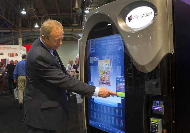 Grant Prichard uses a touchscreen to Cheetos from a  diji-touch vending machine at the U-Select-It booth during the NAMA (National Automatic Merchandising Association) One Show at the Sands Expo Center Wednesday, April 25, 2013. The NAMA One Show convention serves the vending, coffee and food service industries.