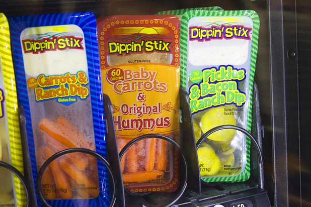 Healthy snacks are shown in a vending machine at a Reichel Foods booth during the NAMA (National Automatic Merchandising Association) One Show at the Sands Expo Center Wednesday, April 25, 2013. The NAMA One Show convention serves the vending, coffee and food service industries.