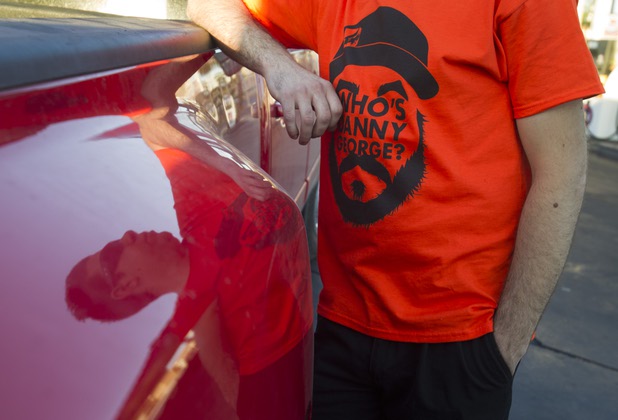 Crew chief Kyle LeBlanc is reflected in the side of a pick-up truck before heading to the Willow Springs International Raceway near Rosamund, Calif. with Formula Drift driver Danny George Sunday, April 28, 2013.