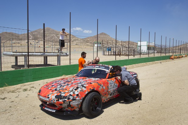 Crew members talk with Formula Drift driver Danny George of Las Vegas during testing at the Willow Springs International Raceway near Rosamund, Calif. Sunday, April 28, 2013. George will compete in round two of the 2013 season at Atlanta on May 10-11.