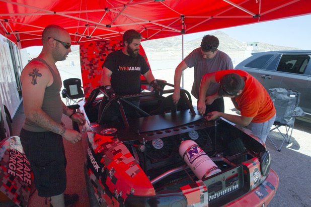 Formula Drift driver Danny George, center, of Las Vegas and his team deal with an overheating problem during testing with the 1990 WreckHouse Mazda Miata at the Willow Springs International Raceway near Rosamund, Calif. Sunday, April 28, 2013. Crew members from left are: George Kiriakopoulos, Kyle LeBlanc and Julian Lucas. George will compete in round two of the 2013 season at Atlanta on May 10-11.