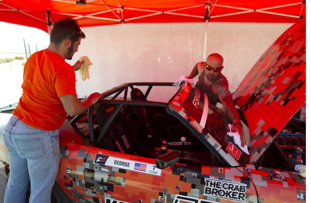 Crew members Julian Lucas, left, and George Kiriakopoulos clean the 1990 WreckHouse Mazda Miata after an overheating problem during testing at the Willow Springs International Raceway near Rosamund, Calif. Sunday, April 28, 2013. Formula Drift driver Danny George of Las Vegas will compete in round two of the 2013 season at Atlanta on May 10-11.