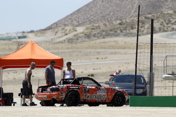 Crew members, from left, George Kiriakopoulos, and Kyle LeBlanc, and Steven Heck talk with Formula Drift driver Danny George of Las Vegas during testing at the Willow Springs International Raceway near Rosamund, Calif. Sunday, April 28, 2013. George will compete in round two of the 2013 season at Atlanta on May 10-11.