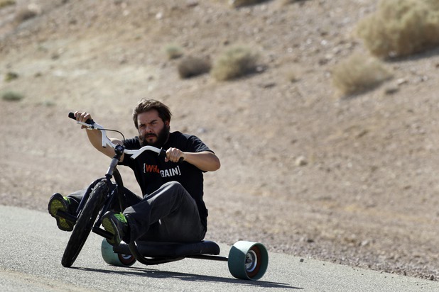 Formula Drift driver Danny George of Las Vegas rides a "drift trike" down a hill at the Willow Springs International Raceway near Rosamund, Calif. Sunday, April 28, 2013.