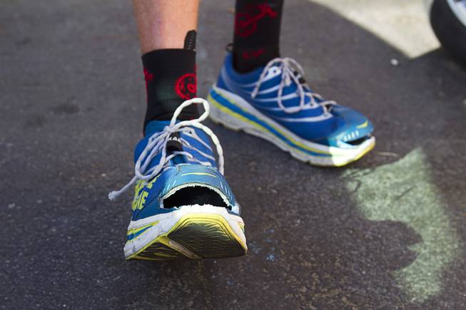 Adam Towle, 37, of Solana Beach, Calif. displays his shoes during the third segment of the MS Run the US, a 3,000 mile relay run from Los Angeles to New York City, in Las Vegas Tuesday, April 30, 2013. Towle said he cut the toes of his running shoes so that he can continue to run even if his feet swell. MS Run the US is a non-profit organization committed to raising disease awareness and funds to further research in the fight to end multiple sclerosis (MS).
