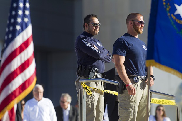 U.S. marshals keep an eye on the crown as Senate Majority Leader Harry Reid (D-NV) arrives for a May Day rally and march for comprehensive immigration reform at the George Federal Building Wednesday, May 1, 2013.