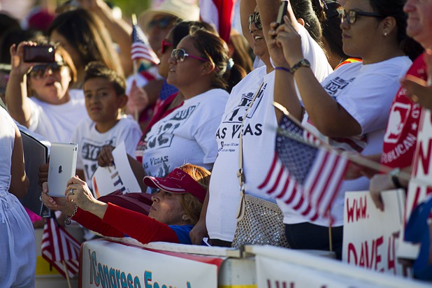 A woman takes a photo with her iPad during a May Day rally and march for comprehensive immigration reform in downtown Las Vegas Wednesday, May 1, 2013. The event started at the George Federal Building downtown, then marchers traveled south on Las Vegas Boulevard, finishing with a rally at St. Louis Square near the Stratosphere.