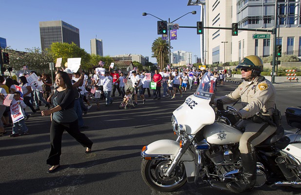 Metro Police motorcycle officers and officers on horseback helped with traffic control during a May Day rally and march for comprehensive immigration reform in downtown Las Vegas Wednesday, May 1, 2013. The event started at the George Federal Building downtown, then marchers traveled south on Las Vegas Boulevard, finishing with a rally at St. Louis Square near the Stratosphere.