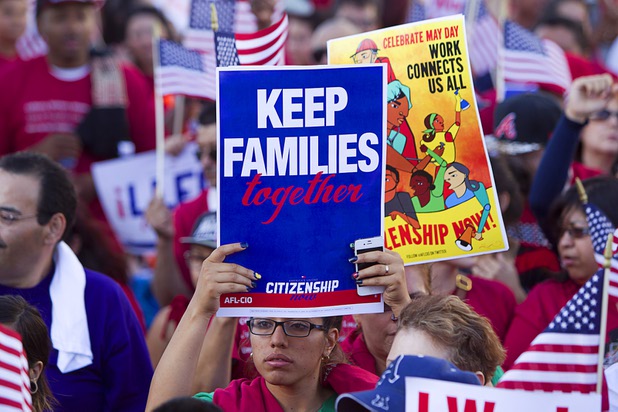 A woman holds up a sign during a May Day rally and march for comprehensive immigration reform in downtown Las Vegas Wednesday, May 1, 2013. The event started at the George Federal Building downtown, then marchers traveled south on Las Vegas Boulevard, finishing with a rally at St. Louis Square near the Stratosphere.