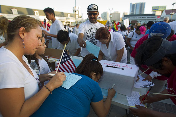 Marchers fill out action cards after arriving at at St. Louis Square during a May Day rally and march for comprehensive immigration reform Wednesday, May 1, 2013. The event started at the George Federal Building downtown, then marchers traveled south on Las Vegas Boulevard, finishing with a rally at St. Louis Square near the Stratosphere.