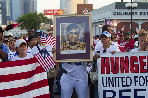 A man holds a photo of labor leader and civil rights activist Cesar Chavez during a May Day rally and march for comprehensive immigration reform at St. Louis Square Wednesday, May 1, 2013. The event started at the George Federal Building downtown, then marchers traveled south on Las Vegas Boulevard, finishing with a rally at St. Louis Square near the Stratosphere.