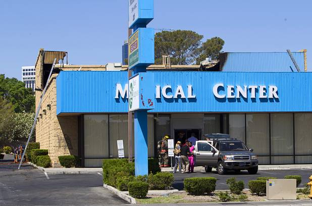 Workers move medical equipment into a sport utility vehicle after a fire at a medical building at Maryland Parkway near Vegas Valley Drive Wednesday,  May 1, 2013.