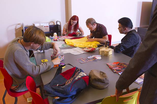 People prepare for prom at the Center Wednesday, May 1, 2013. "Gaymer," the 2013 LGBTQ youth prom, is scheduled for Saturday, May 4. The dress is video game-themed costumes or prom attire. Clockwise from left are: Andy Ros, Gaylyn Daniels, Taylor Johns and Anthony Lyles.