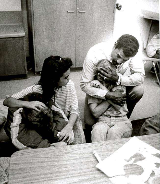 A teacher and student comfort students at Laura Dearing Elementary School who are visibly upset May 5, 1988, a day after two explosions destroyed PEPCON. Two people died and about 300 were injured in the blasts.