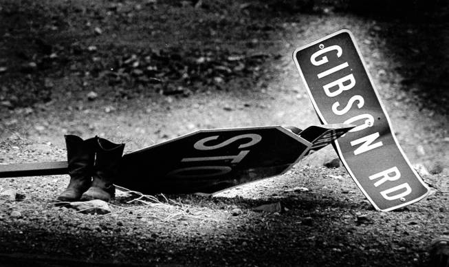 A stop sign, street signs and boots lay on the ground May 5, 1988, after the blasts at the Pacific Engineering Production Company of Nevada plant May 4, 1988. The plant was located at what is now Gibson Road and Wigwam Parkway. PEPCON eventually rebuilt in Utah.