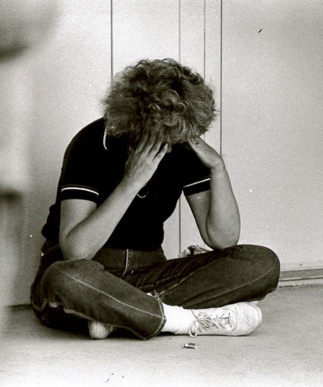 A worried parent cries at Cannon Junior High School on May 5, 1988, the day after blasts destroyed the Pacific Engineering Production Company of Nevada complex, killing two people and injuring 300.