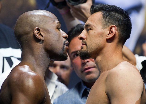 Floyd Mayweather Jr. and Robert Guerrero stare down each other after making weight Friday, May 3, 2013, at MGM Grand Garden Arena for their WBC welterweight title fight Saturday night.
