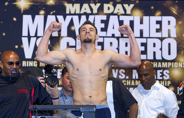 Welterweight boxer Robert Guerrero flexes on the scale during an official weigh-in at the MGM Grand Garden Arena Friday, May 3, 2013. Guerrero will challenge undefeated WBC welterweight champion Floyd Mayweather Jr. for the title at the arena on Saturday.