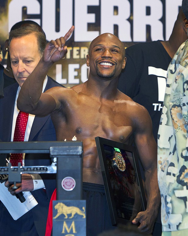 Undefeated WBC welterweight champion Floyd Mayweather Jr. acknowledges the crowd during an official weigh-in at the MGM Grand Garden Arena Friday, May 3, 2013. Mayweather will defend his title against Robert Guerrero at the arena on Saturday.