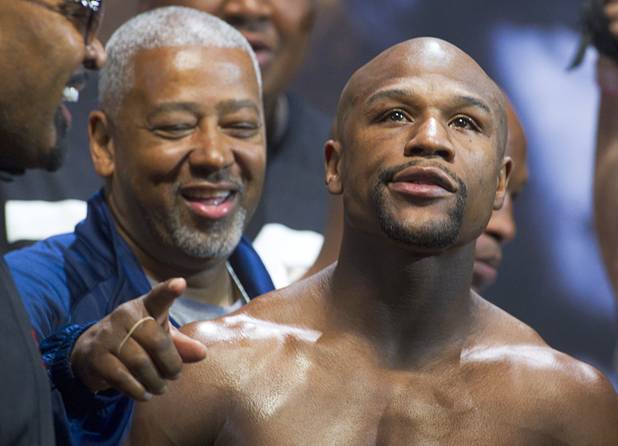 Undefeated WBC welterweight champion Floyd Mayweather Jr. looks into the crowd during an official weigh-in at the MGM Grand Garden Arena Friday, May 3, 2013. Mayweather will defend his title against Robert Guerrero at the arena on Saturday.