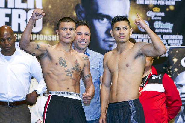 WBC featherweight champion Daniel Ponce De Leon of Mexico and Abner Mares, also of Mexico, pose during an official weigh-in at the MGM Grand Garden Arena Friday, May 3, 2013. De Leon will defend his title against Mares at the arena on Saturday.