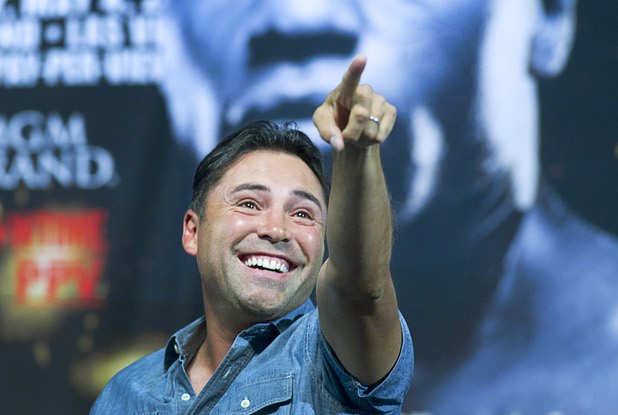 Oscar De La Hoya points to someone in the crowd before an official weigh-in for WBC welterweight champion Floyd Mayweather Jr. and Robert Guerrero at the MGM Grand Garden Arena Friday, May 3, 2013. Mayweather will defend his title against Guerrero at the arena on Saturday.