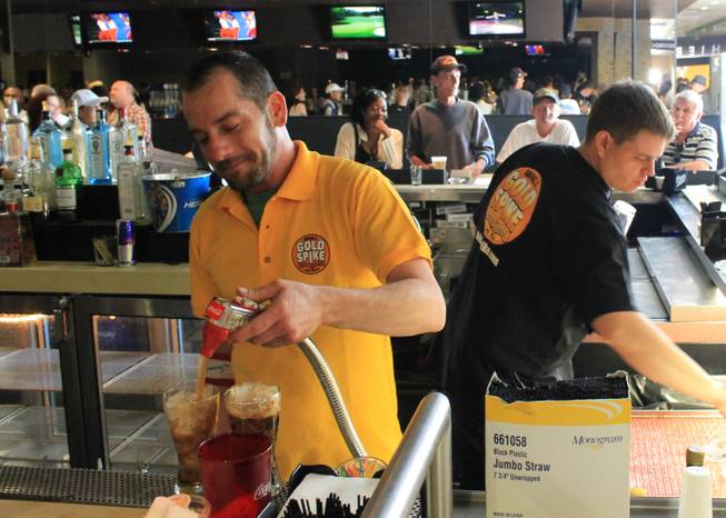 Bartender J.C. Kelley pours a couple of sodas about an hour before the doors closed for the final time April 14, 2013, at Gold Spike in Downtown Las Vegas. Gold Spike is reopening Monday, May 6, 2013, as a bar and restaurant.