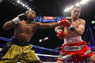 WBC welterweight champion Floyd Mayweather Jr., left, connects a punch on Robert Guerrero during their title fight at the MGM Grand Garden Arena Saturday, May 4, 2013. 