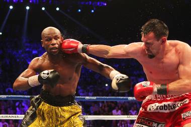 Robert Guerrero hits Floyd Mayweather with a right during their fight Saturday, May 4, 2013 at the MGM Grand Garden Arena. Mayweather won a unanimous decision to retain his welterweight titles.