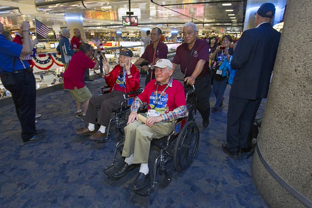 World War II veterans Claude Bateman Jr., left, 87, and Gilbert Fodel, 91, are welcomed back after the first Las Vegas Honor Flight at McCarran International Airport Sunday, May 5, 2013. About 35 Southern Nevada veterans visited Baltimore and memorials in Washington D.C.